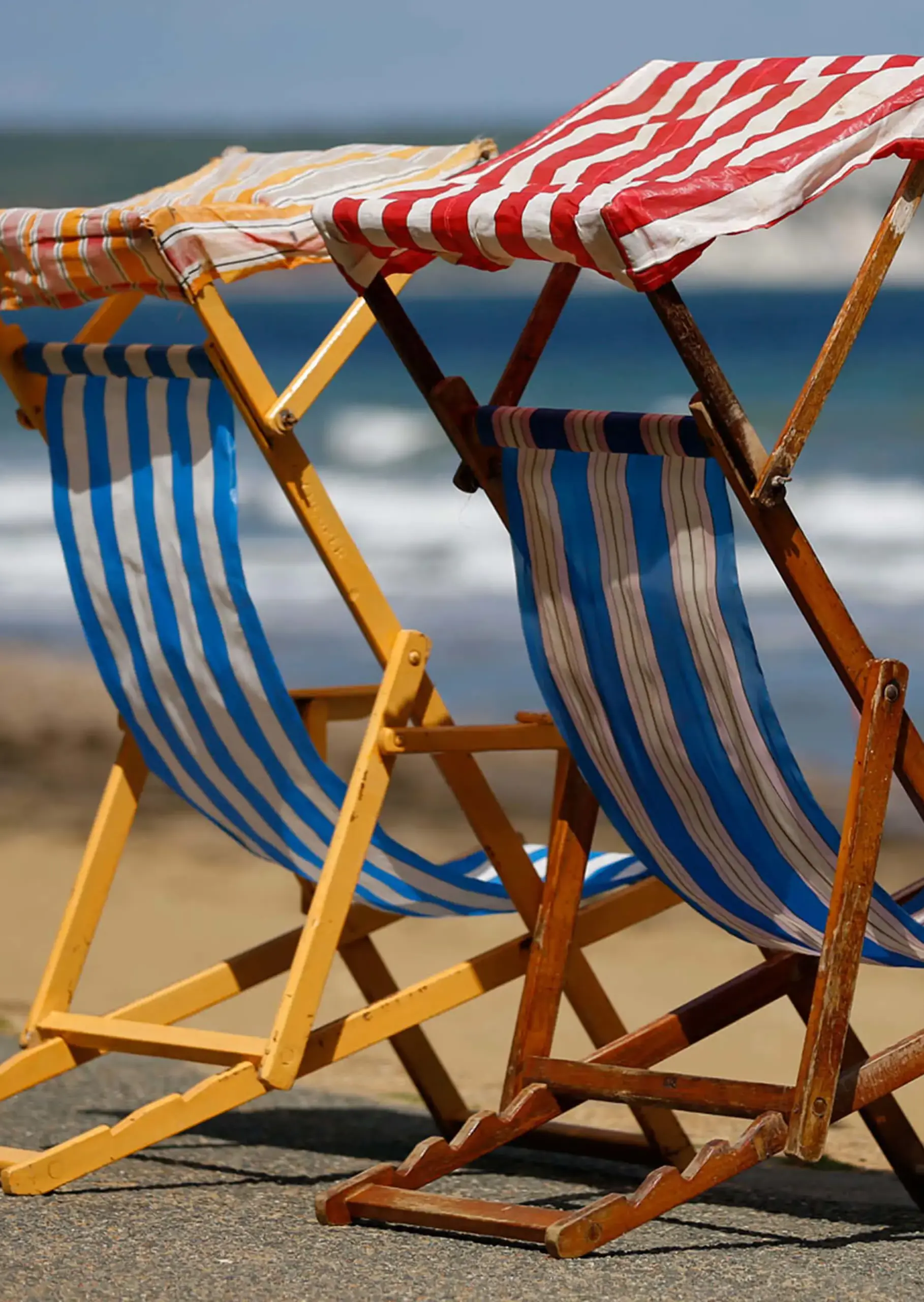 Two deck chairs on an Isle of Wight beach