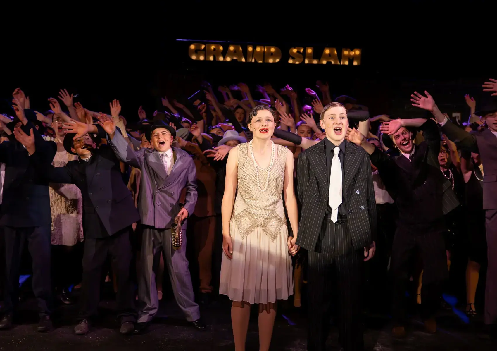 Many Students on stage during production of Bugsy maloneContent Landscape Image