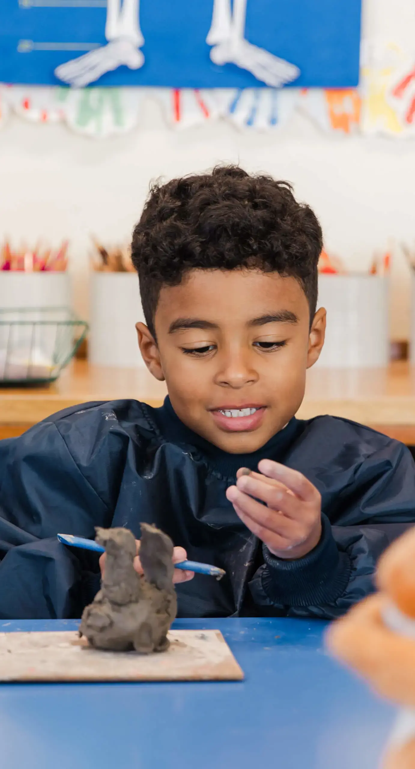 Ryde School Pre-Prep pupil creating art with clay