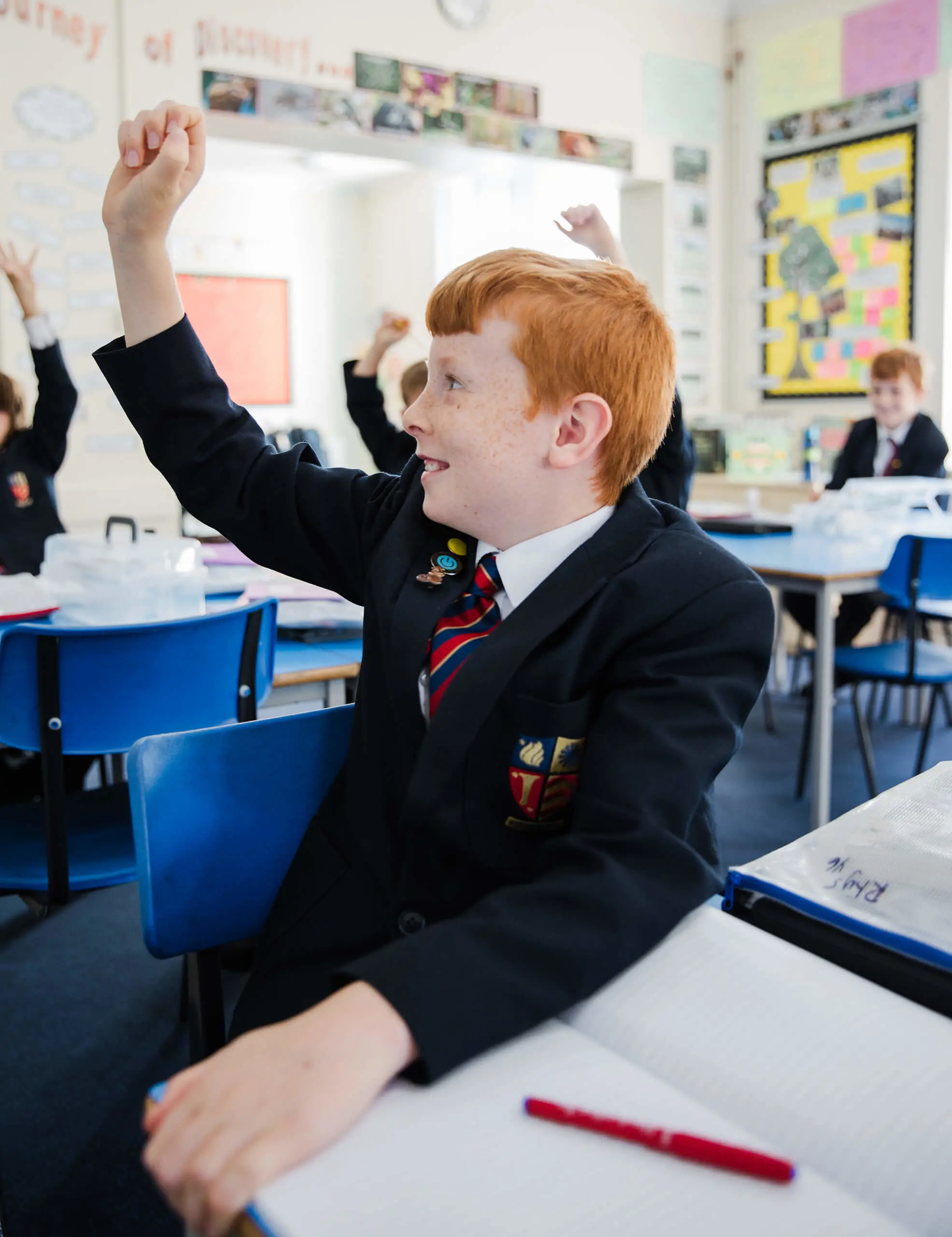 Ryde School Prep pupil with hand up in class