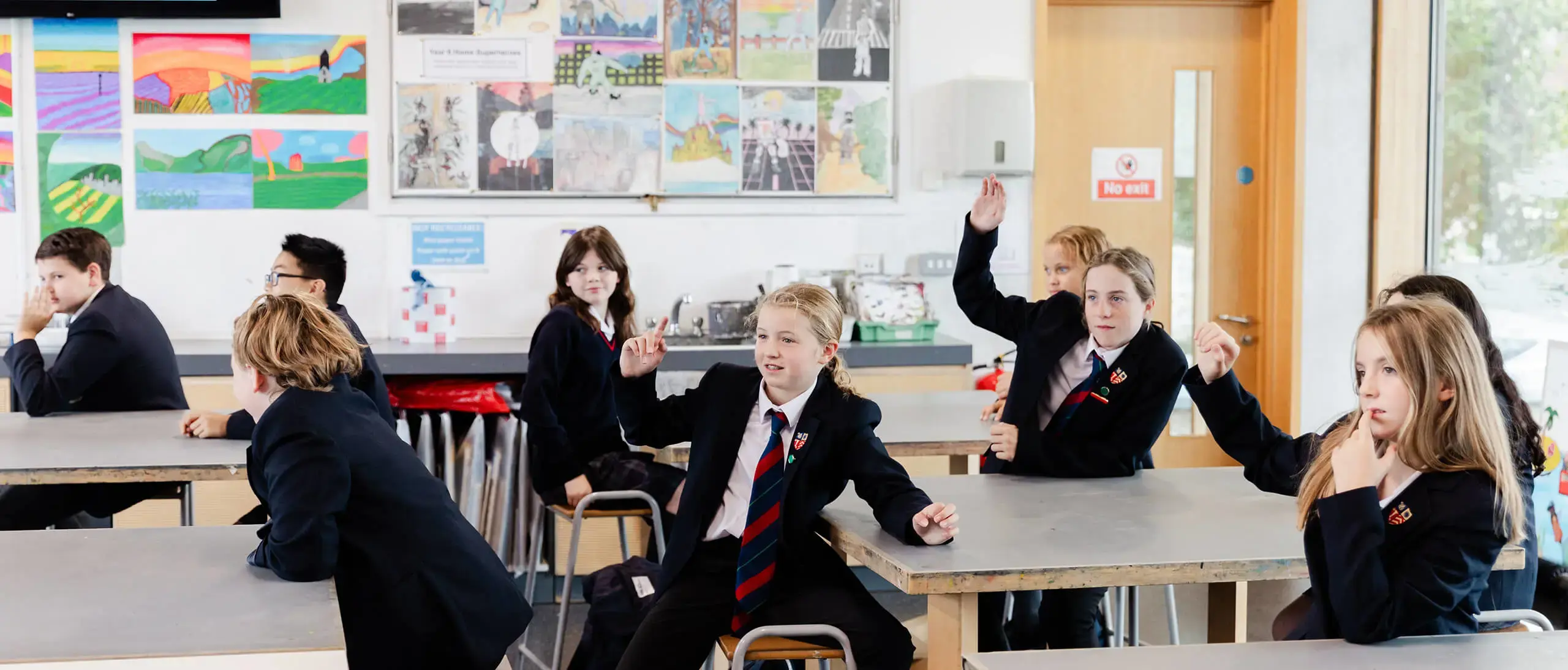 Ryde School Senior Pupils in a lesson with hands up