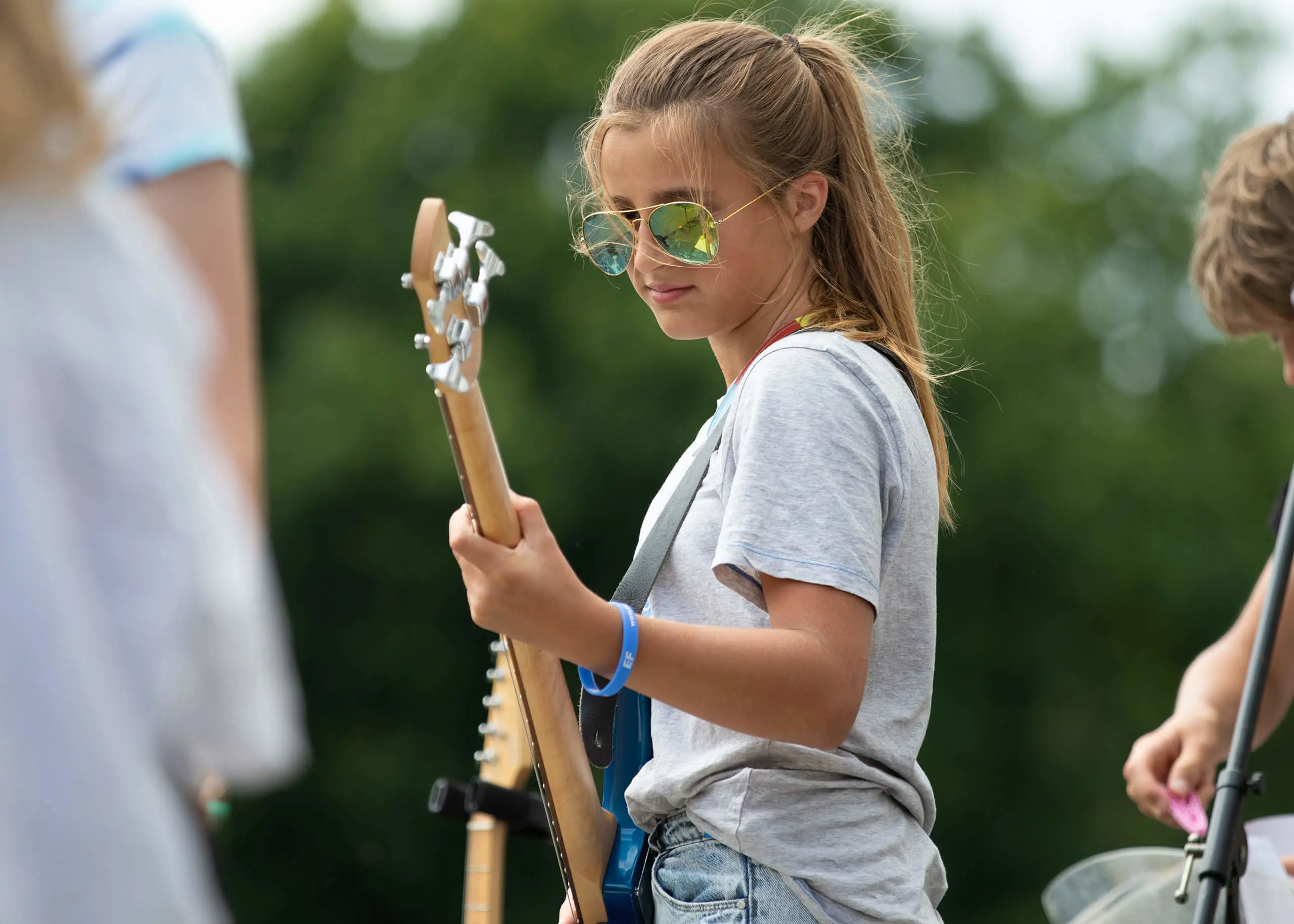 Ryde School Senior pupil playing a guitar outside