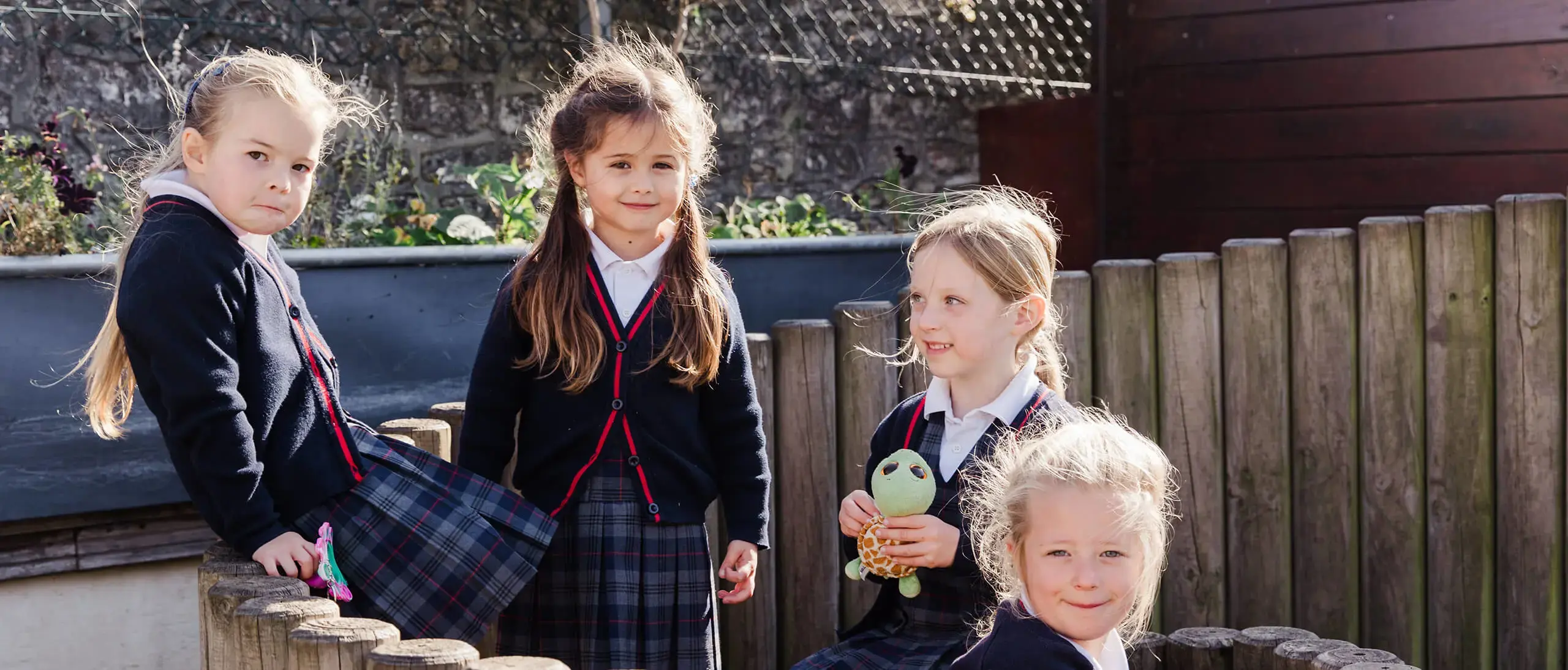 Ryde School Pre-Prep pupils playing outside behind fence