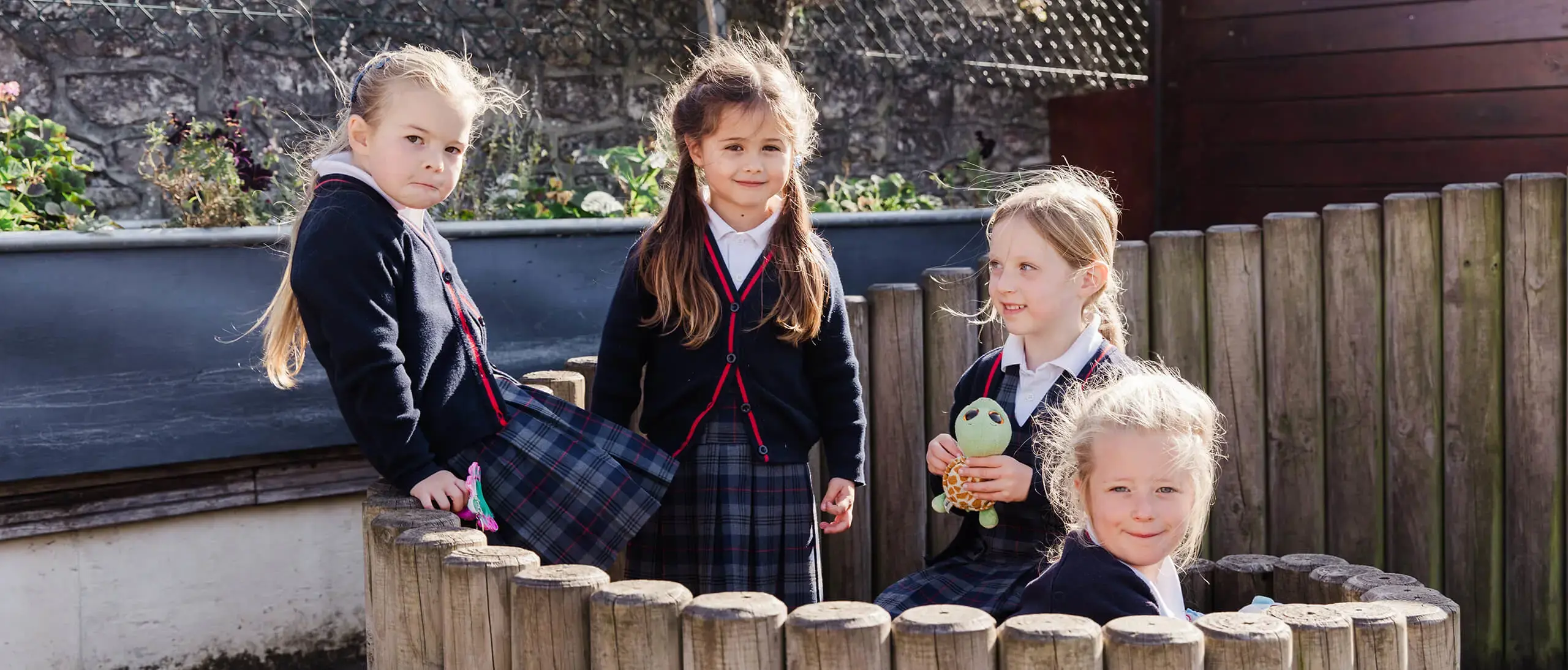 Ryde School Pre-Prep pupils playing outside behind fence