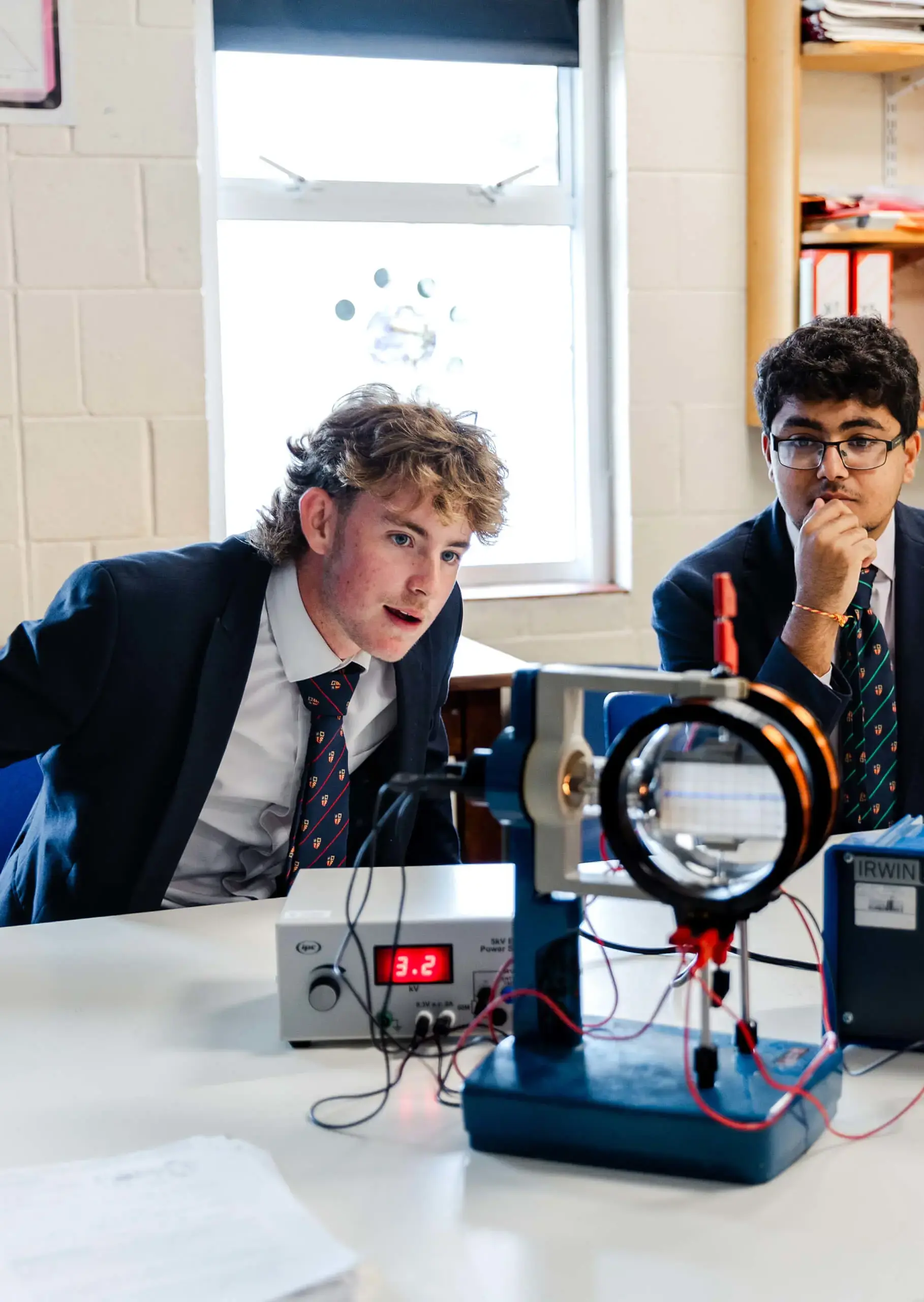 Ryde School pupils looking at science experiment with teacher