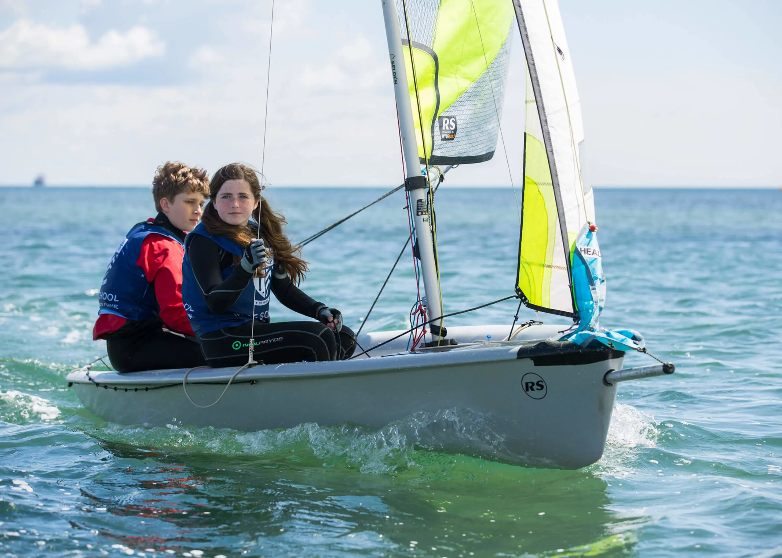 Ryde School Senior pupils sailing a boat with a yellow sail